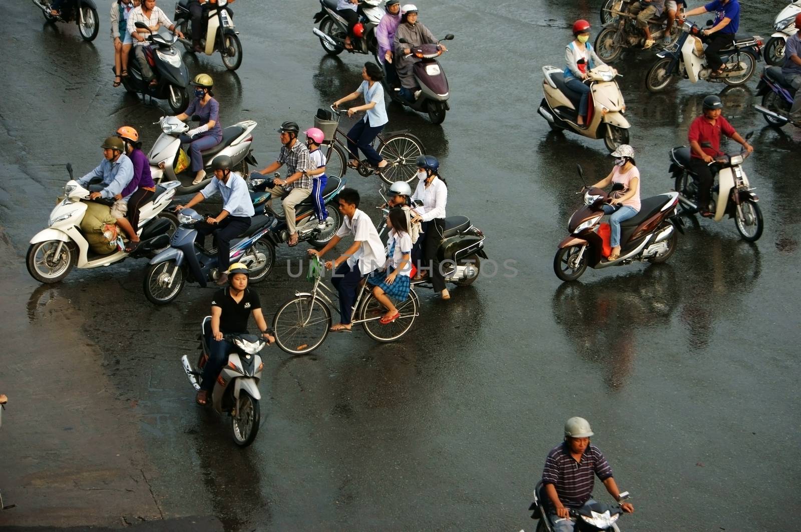 HO CHI MINH, VIET NAM, ASIA- NOV 22: Crowd of people wear helmet, ride motorcycle moving on street in rush hour, they pass by make chaotic traffice in Ho Chi Minh city, Vietnam, Asia on Dec 15, 2012