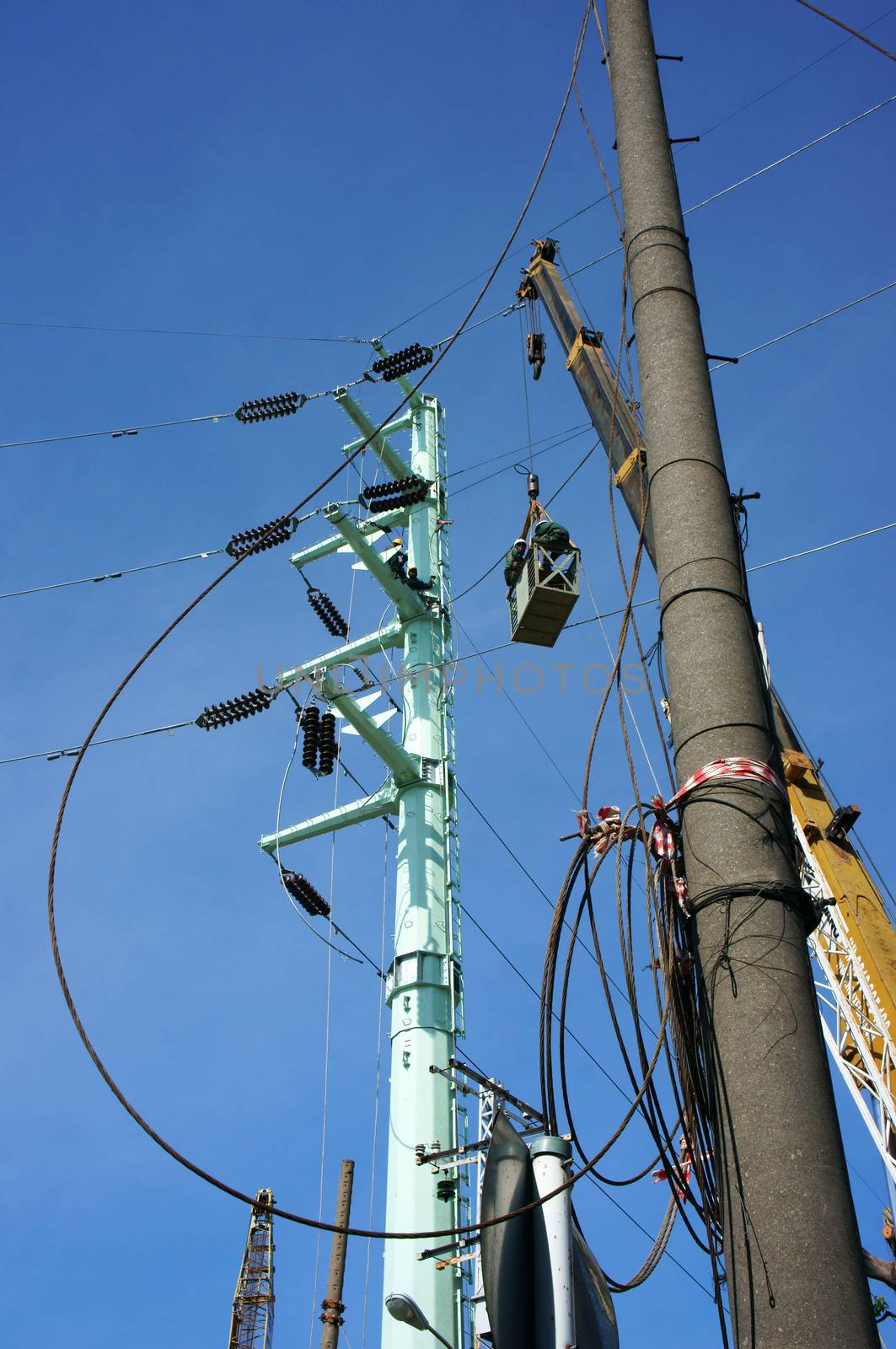 Electrician working among electric wire by xuanhuongho