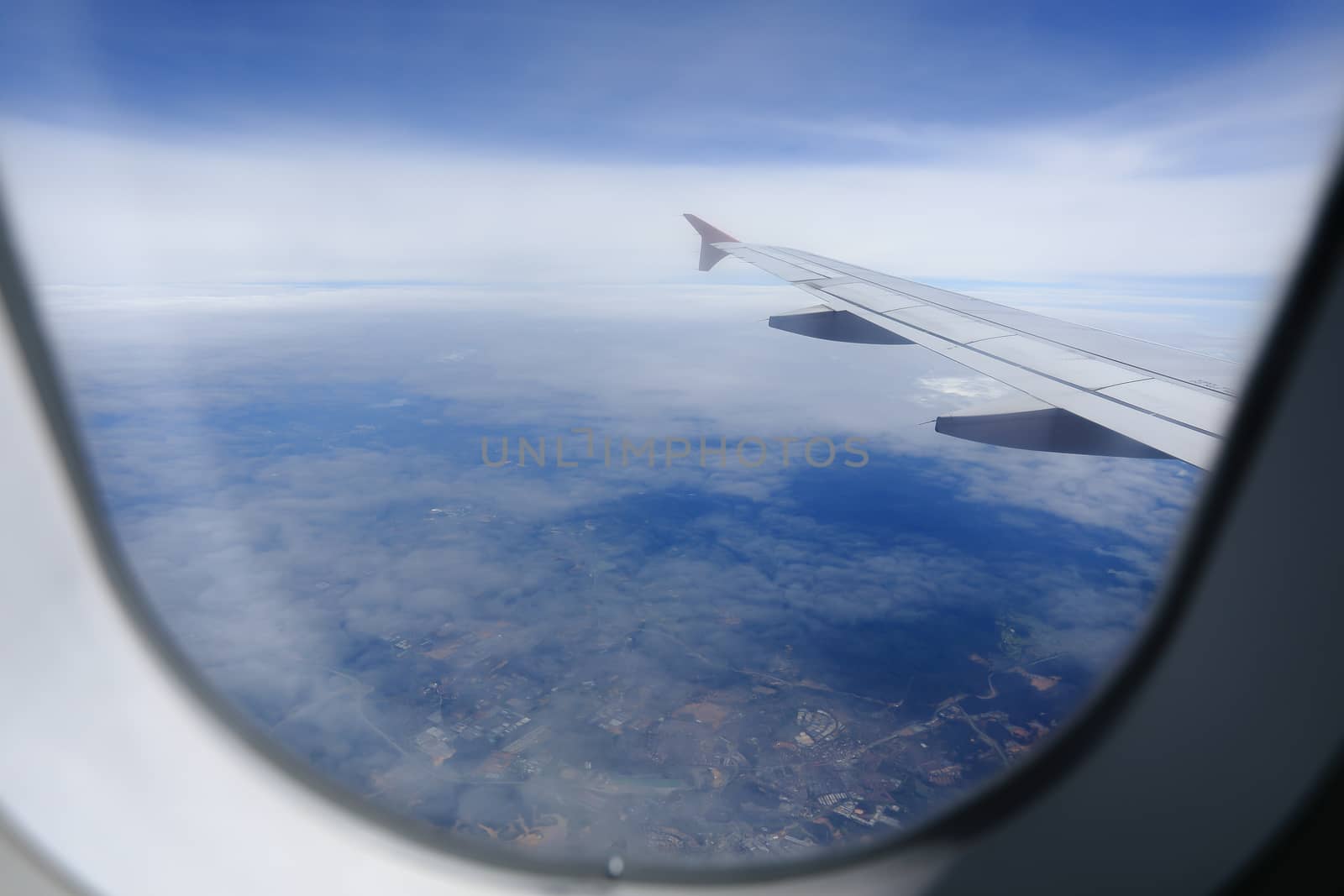 Looking through window aircraft during flight in wing with a nice blue sky