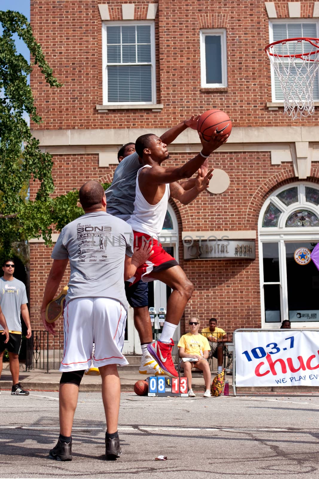 Young Man Drives To Basket In Outdoor Street Basketball Tournament by BluIz60