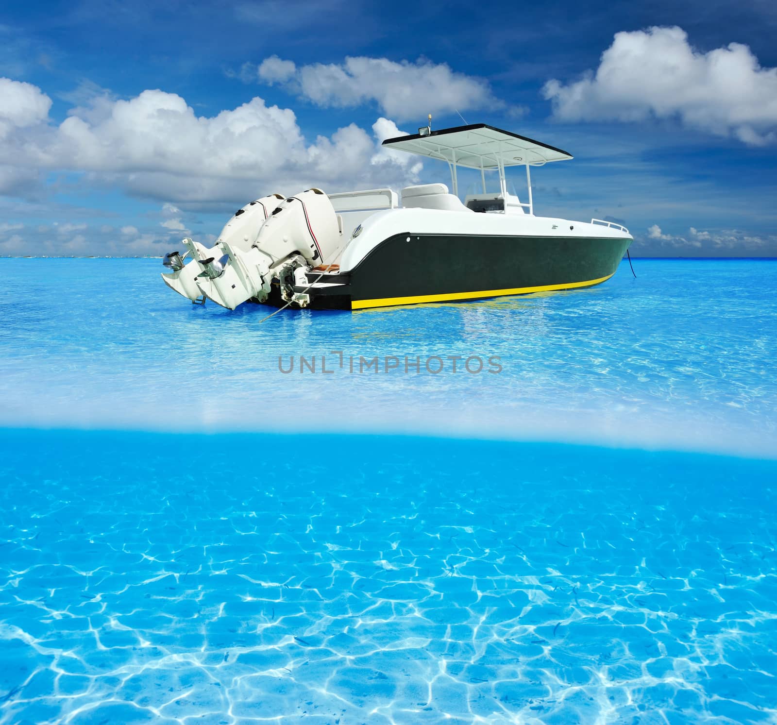 Beach and motor boat with white sand bottom underwater view by haveseen