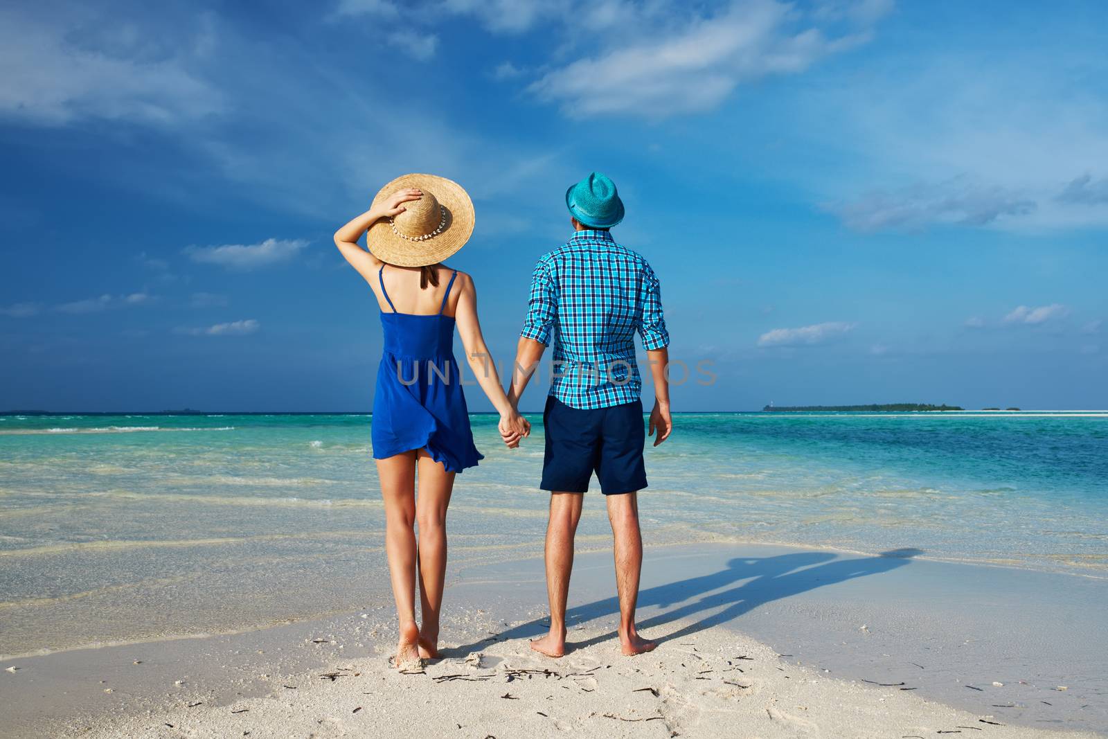 Couple in blue on a tropical beach at Maldives