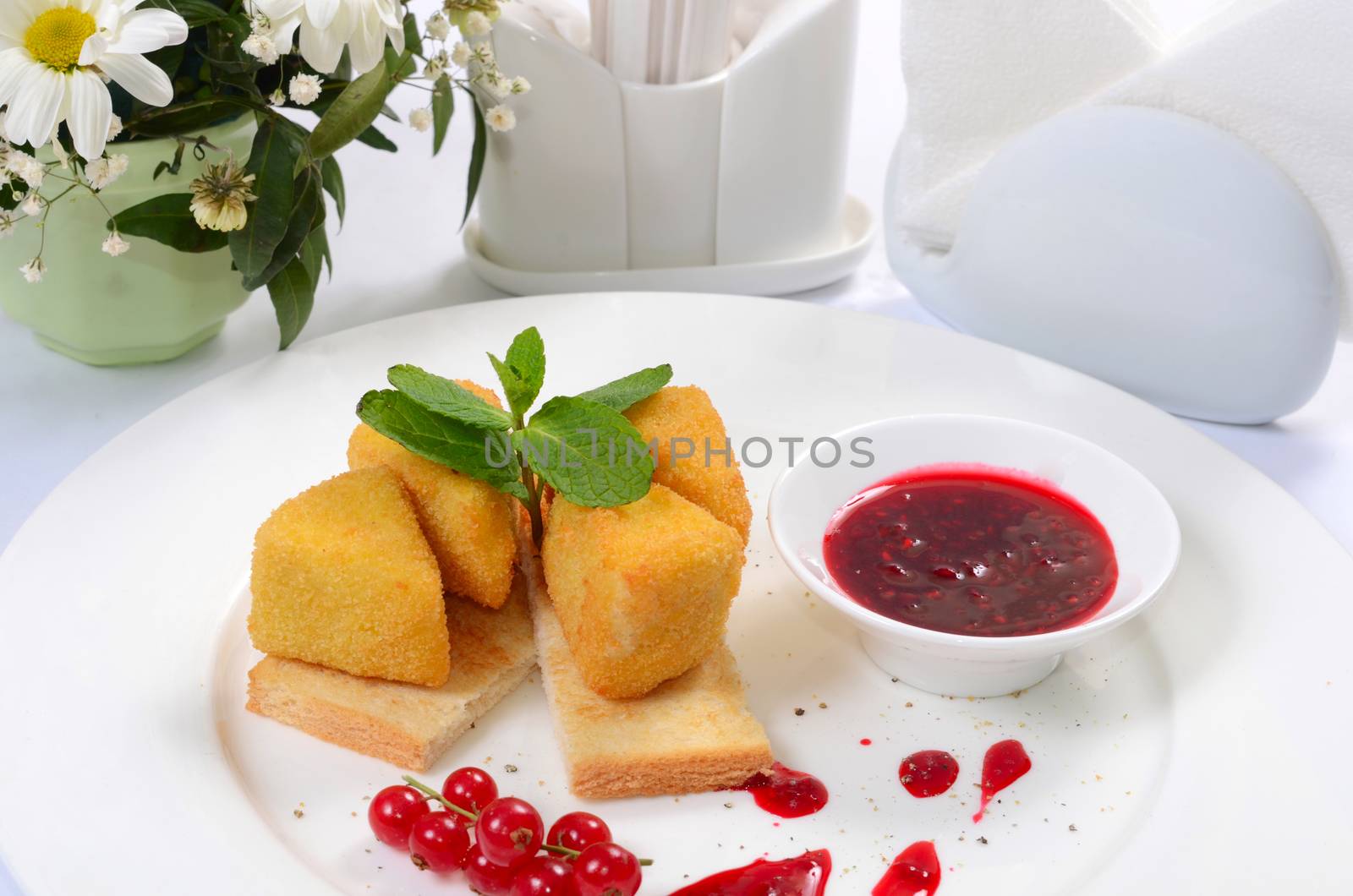 The cheese in breadcrumbs with currant jam