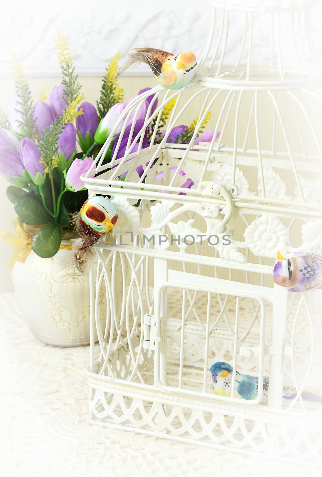 Beautiful cage with birds on the table