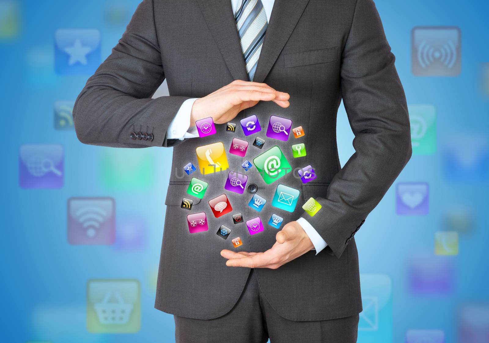 Businessman in a suit holding a app icons by cherezoff