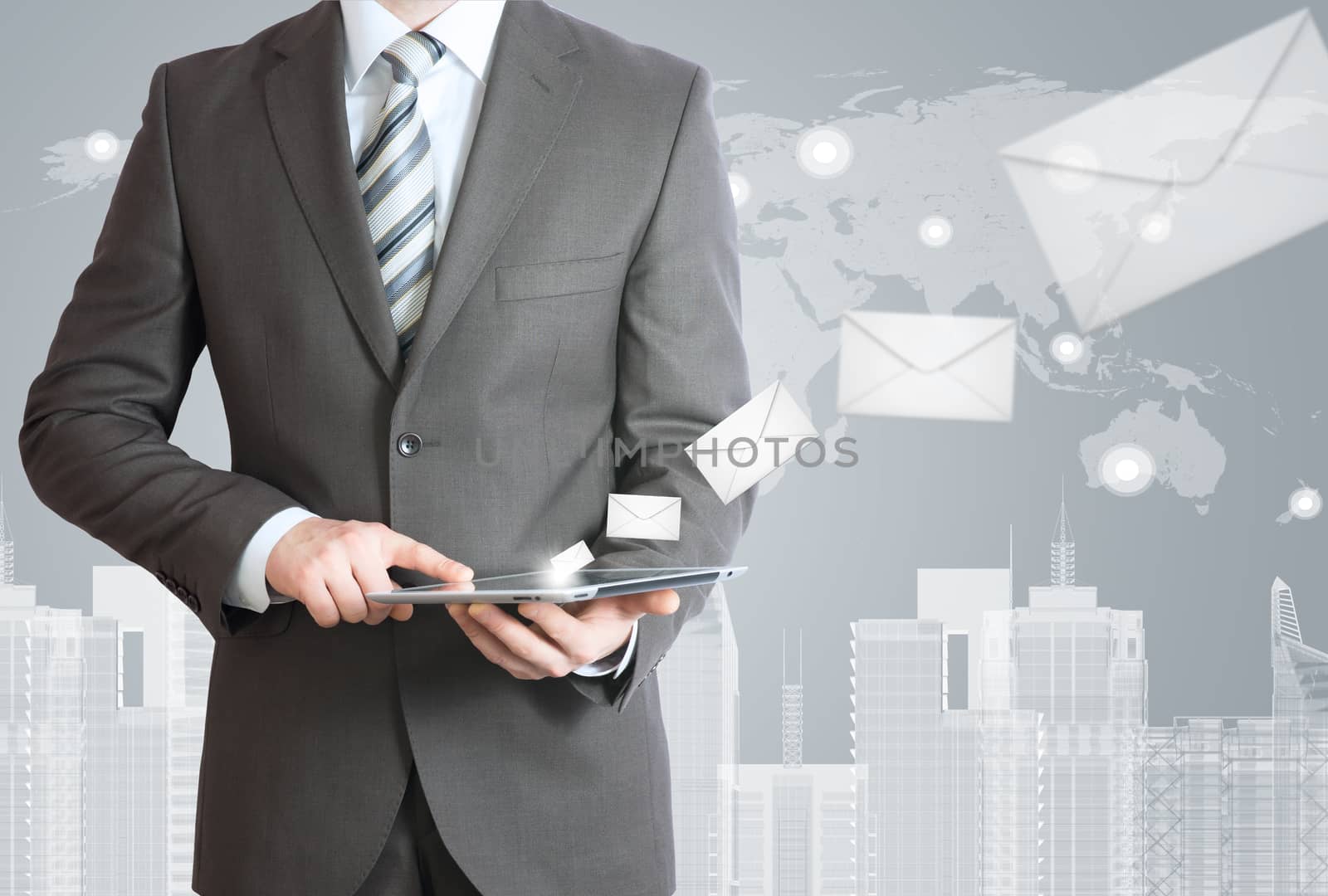 Man in suit holding tablet pc. Envelopes are emitted from the screen tablet. The concept of mailing