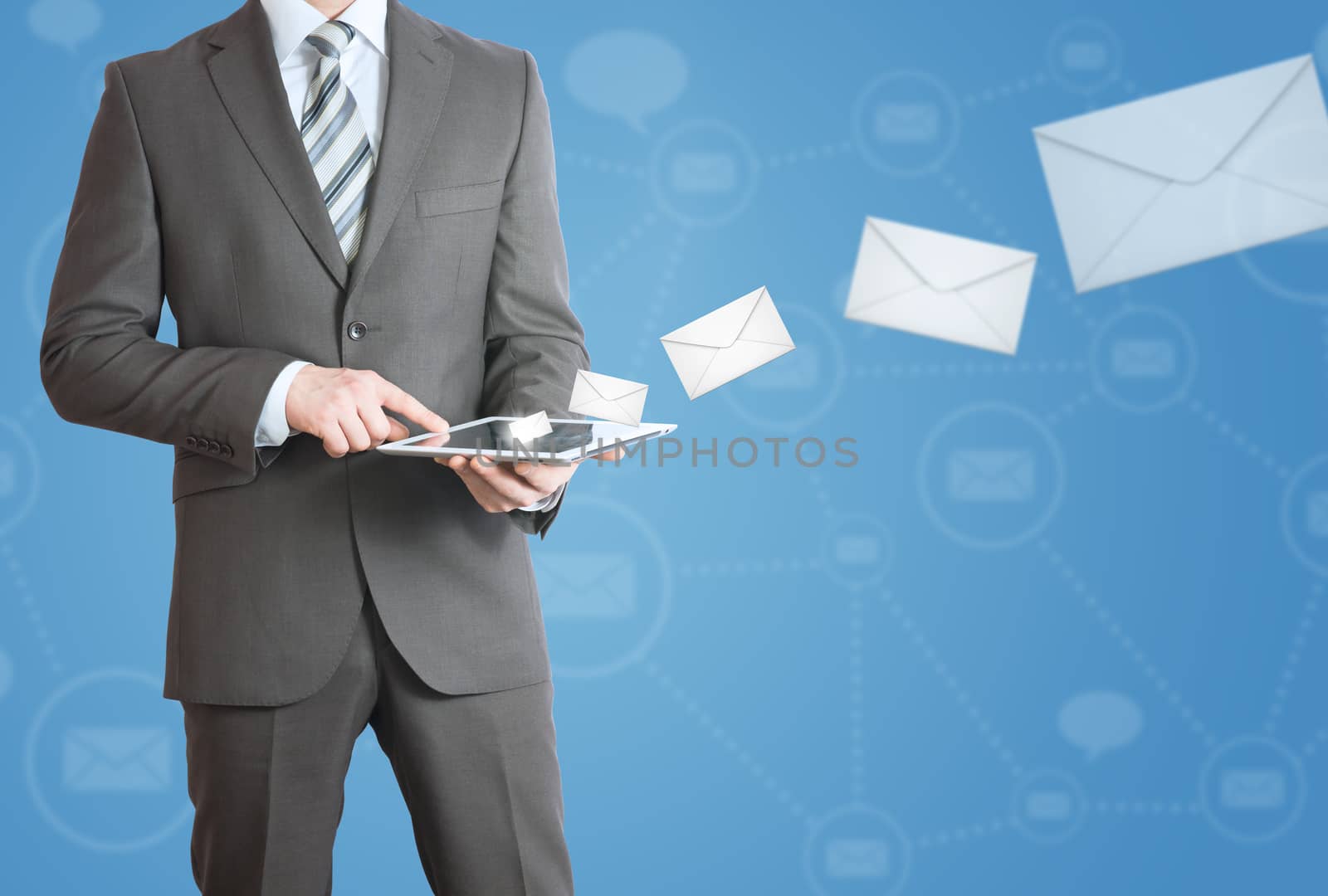 Man in suit holding tablet pc. Envelopes are emitted from the screen tablet. The concept of mailing