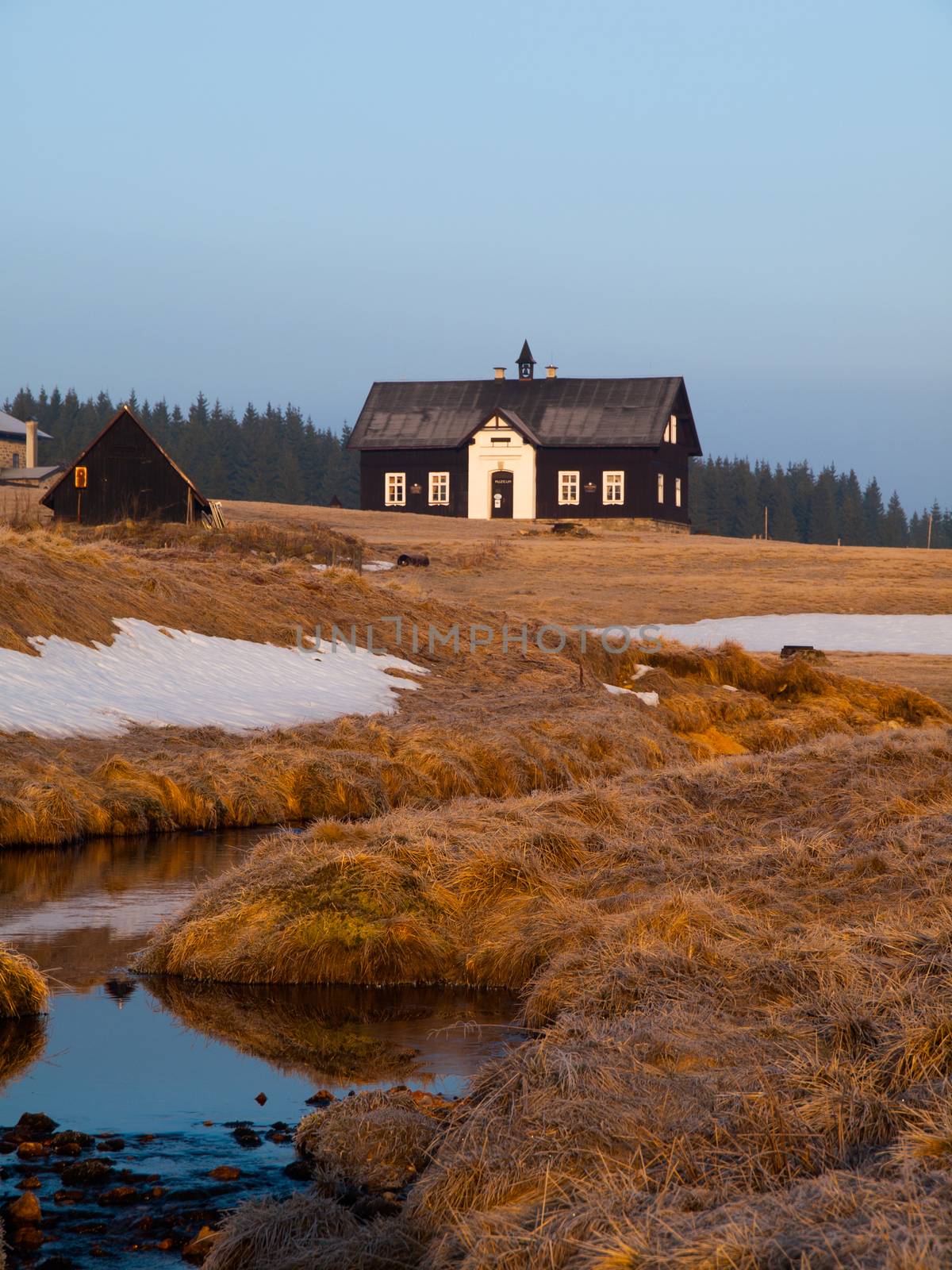 Morning view of typical Jizera Mountains cottage by pyty