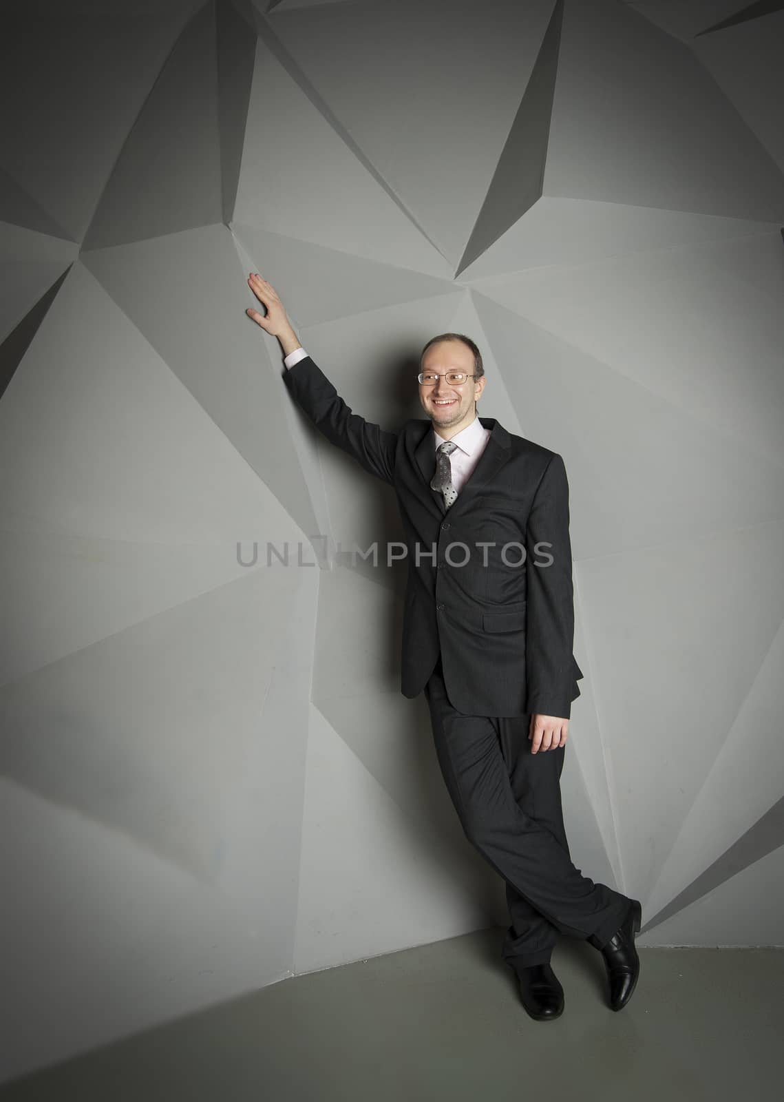  man in a suit and tie on the geometric background