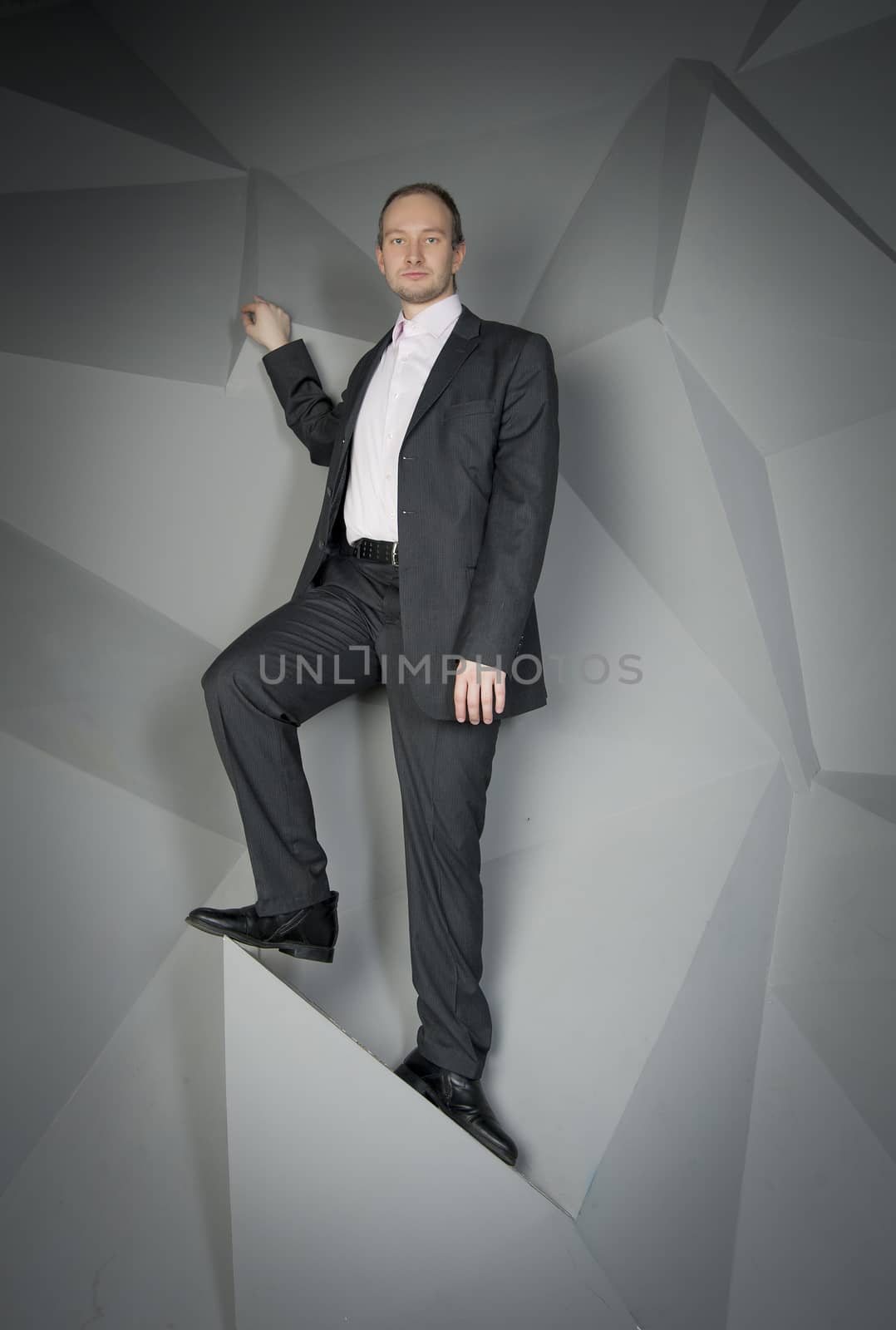  man in a suit and tie on the geometric background