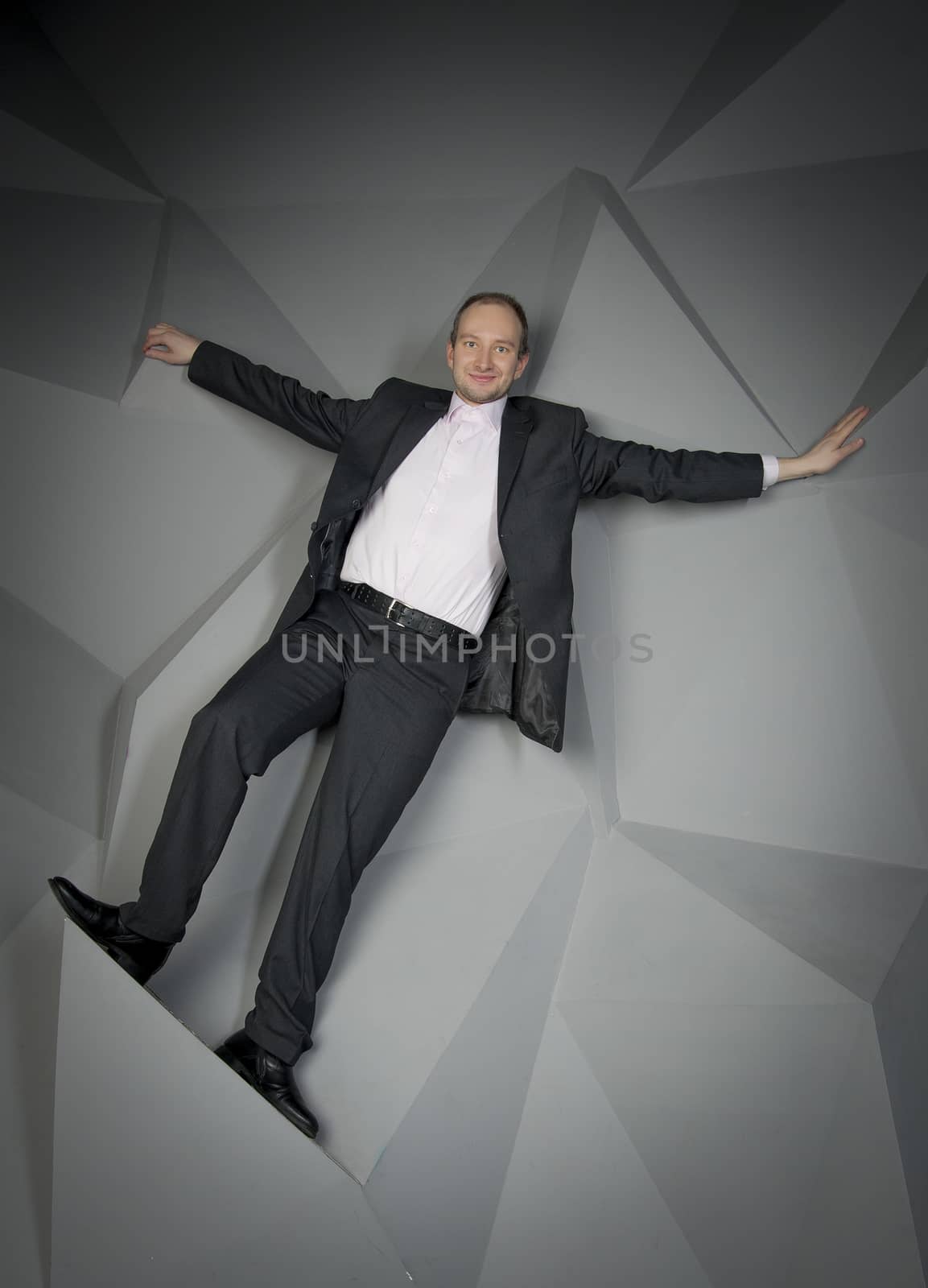  man in a suit and tie on the geometric background