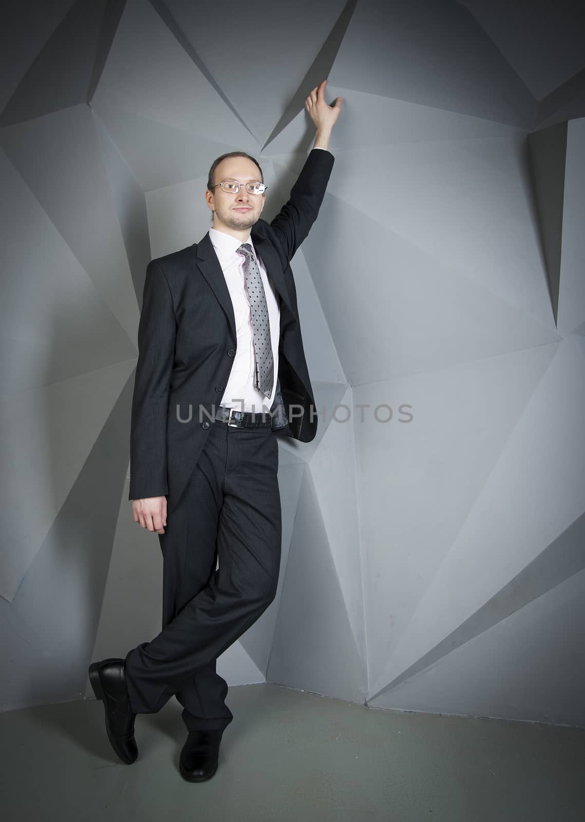  man in a suit and tie on the geometric background