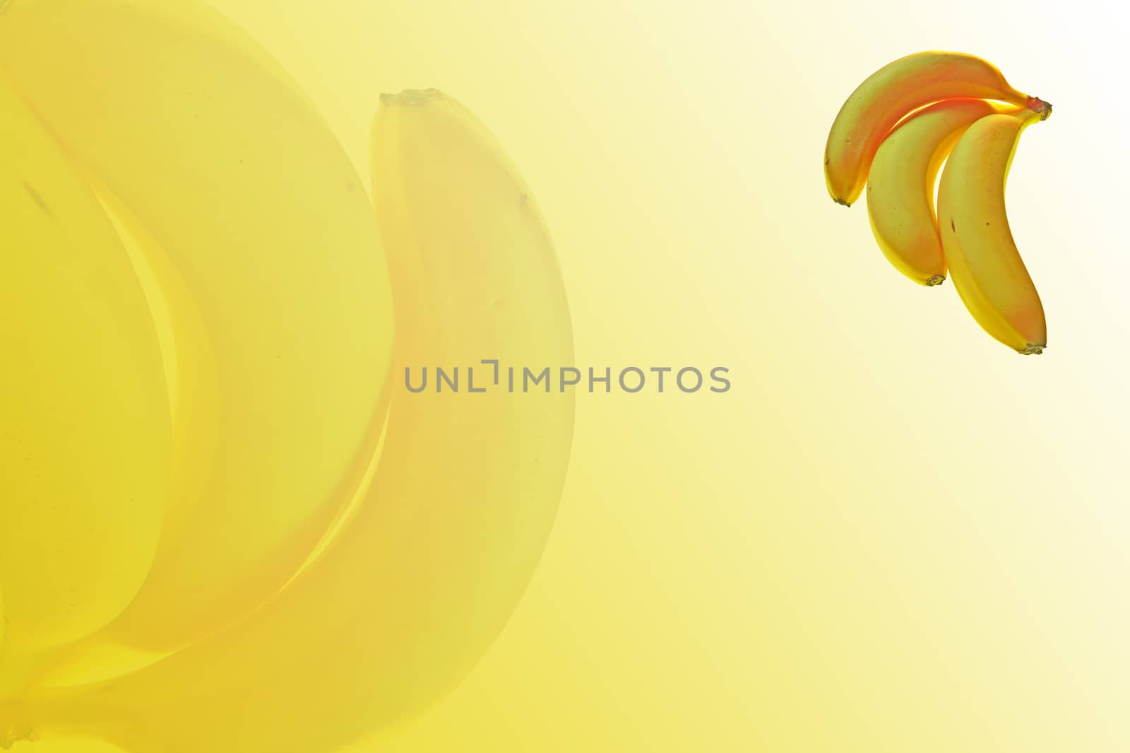  three ripe bananas on abstract yellow background