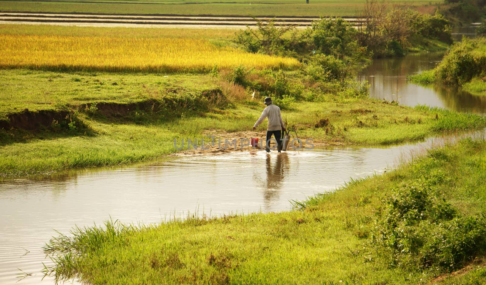  DAK LAK, VIET NAM- SEPTEMBER 5: Farner working on farmland, he take water into spayer from ditch in Daklak, Viet Nam, September 5, 2012     