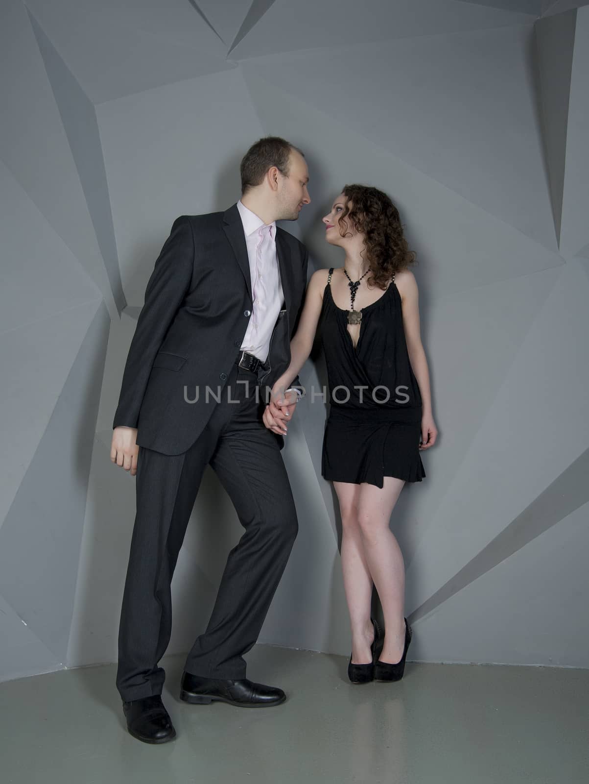 man and woman in love on a grey background