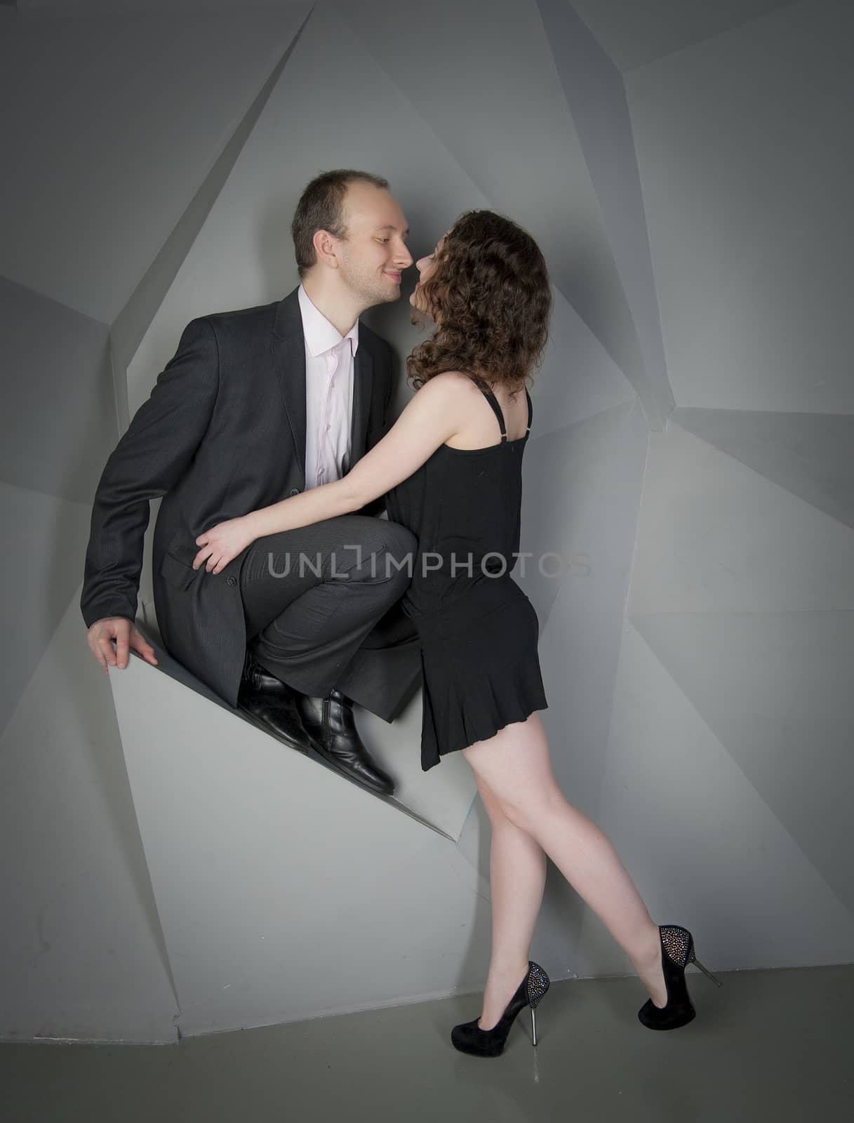 man and woman in love on a grey background