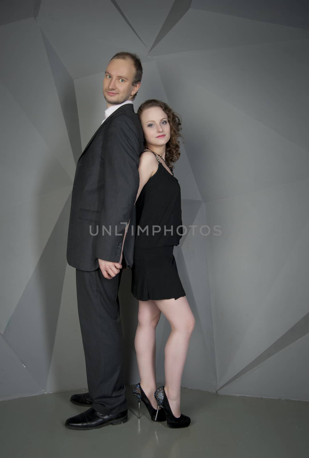 man and woman in love on a grey background