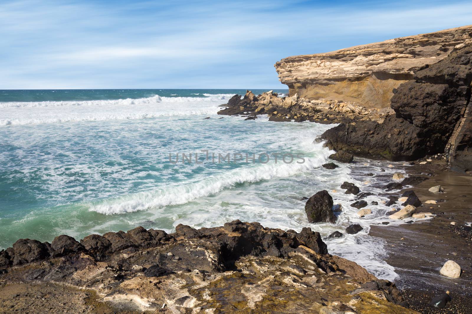 La Pared volcanic beach on Fuerteventura west coast, Canary Islands, Spain, with eroded landscape and black sand.