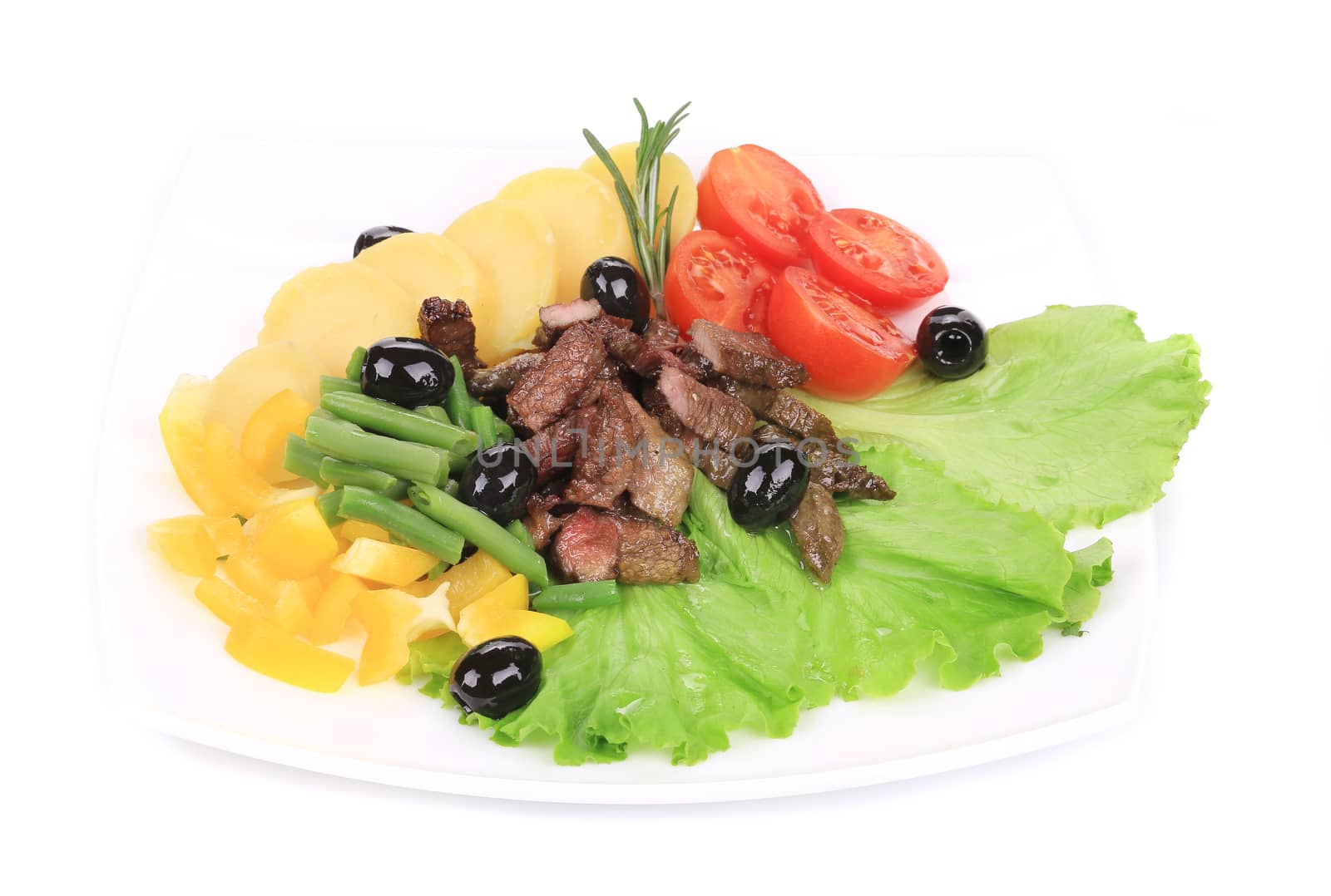 Salad with beef fillet and potatoes. Isolated on a white background.