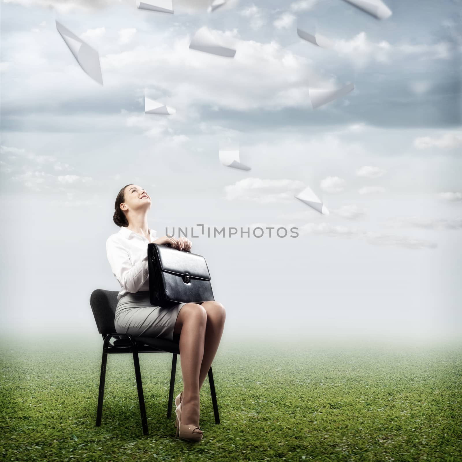 image of a business woman looking at the falling paper