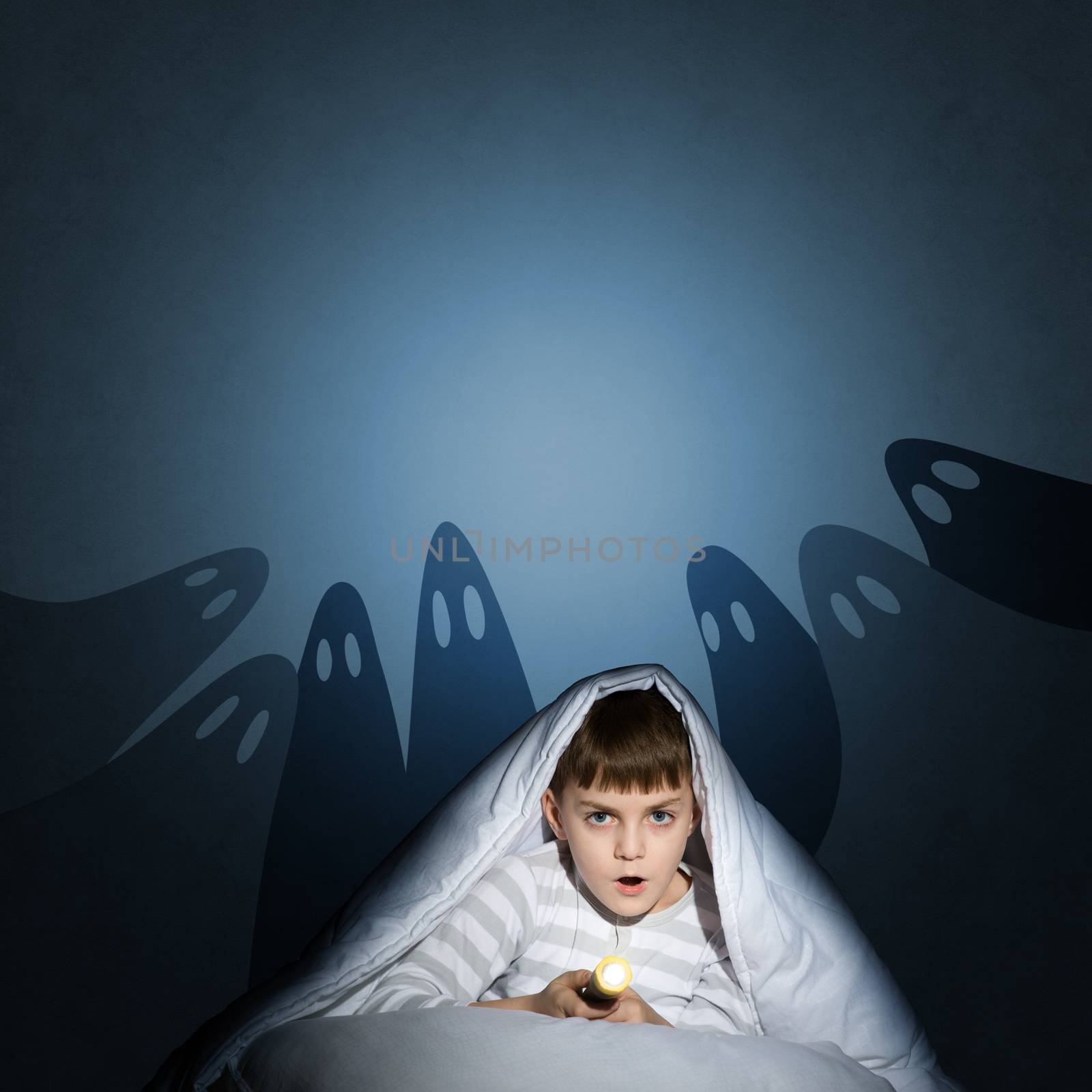 boy under the covers with a flashlight by adam121