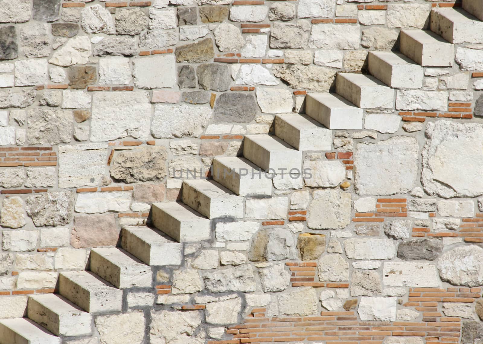 Castle wall without railings leads to the tower.