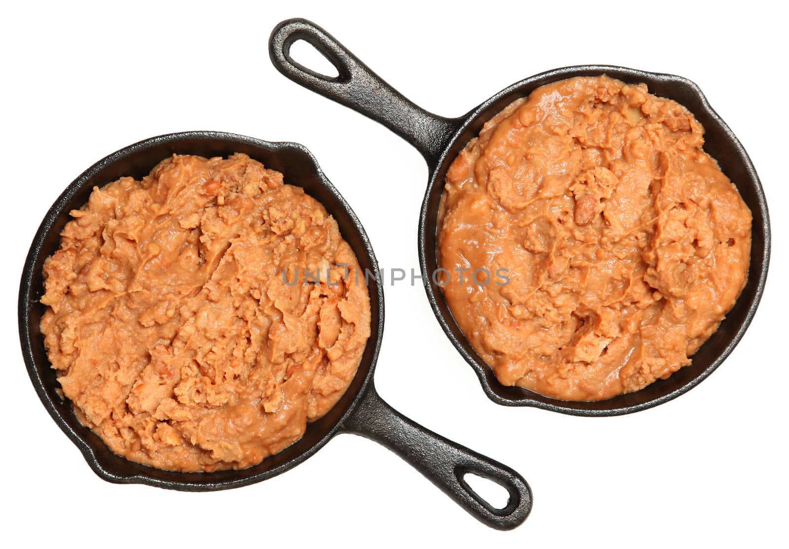 Refried Beans in Skillets Over White by duplass