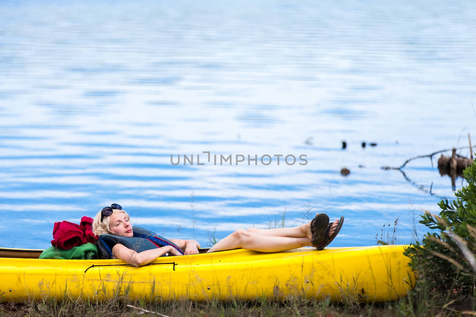 Tired Woman Sleeping in a Yellow Kayak