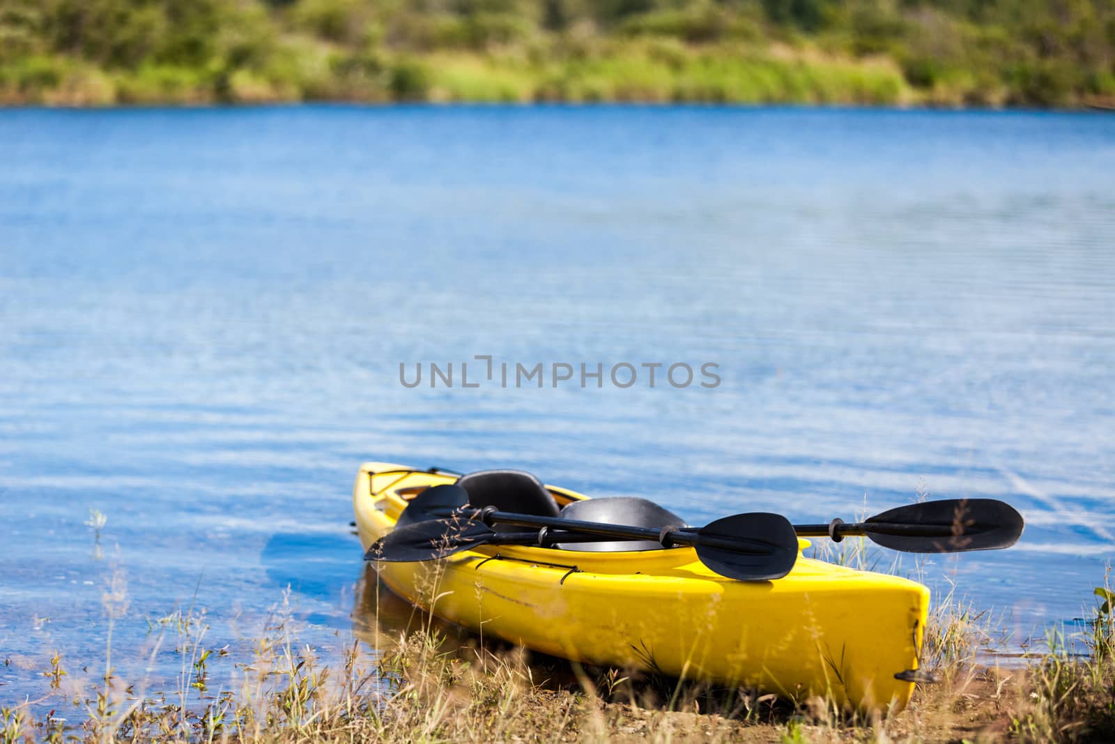 Yellow Kayak Ready to be Used on the Cost of a River