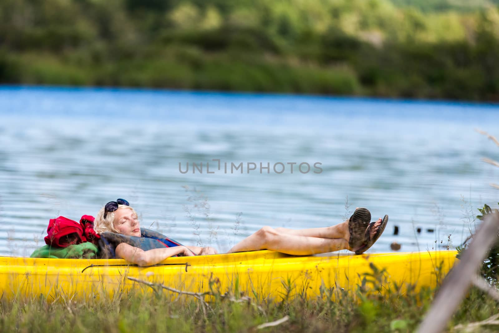 Tired Woman Sleeping in a Yellow Kayak