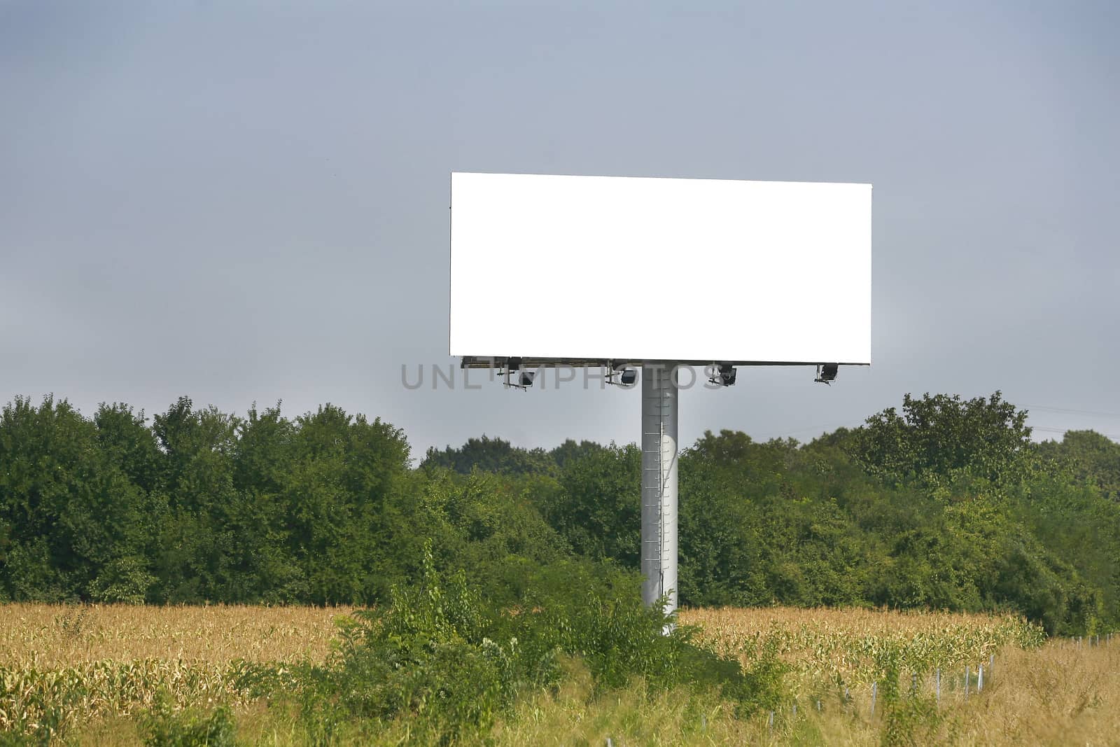 Empty billboard on background of sunset sky for your advertisement