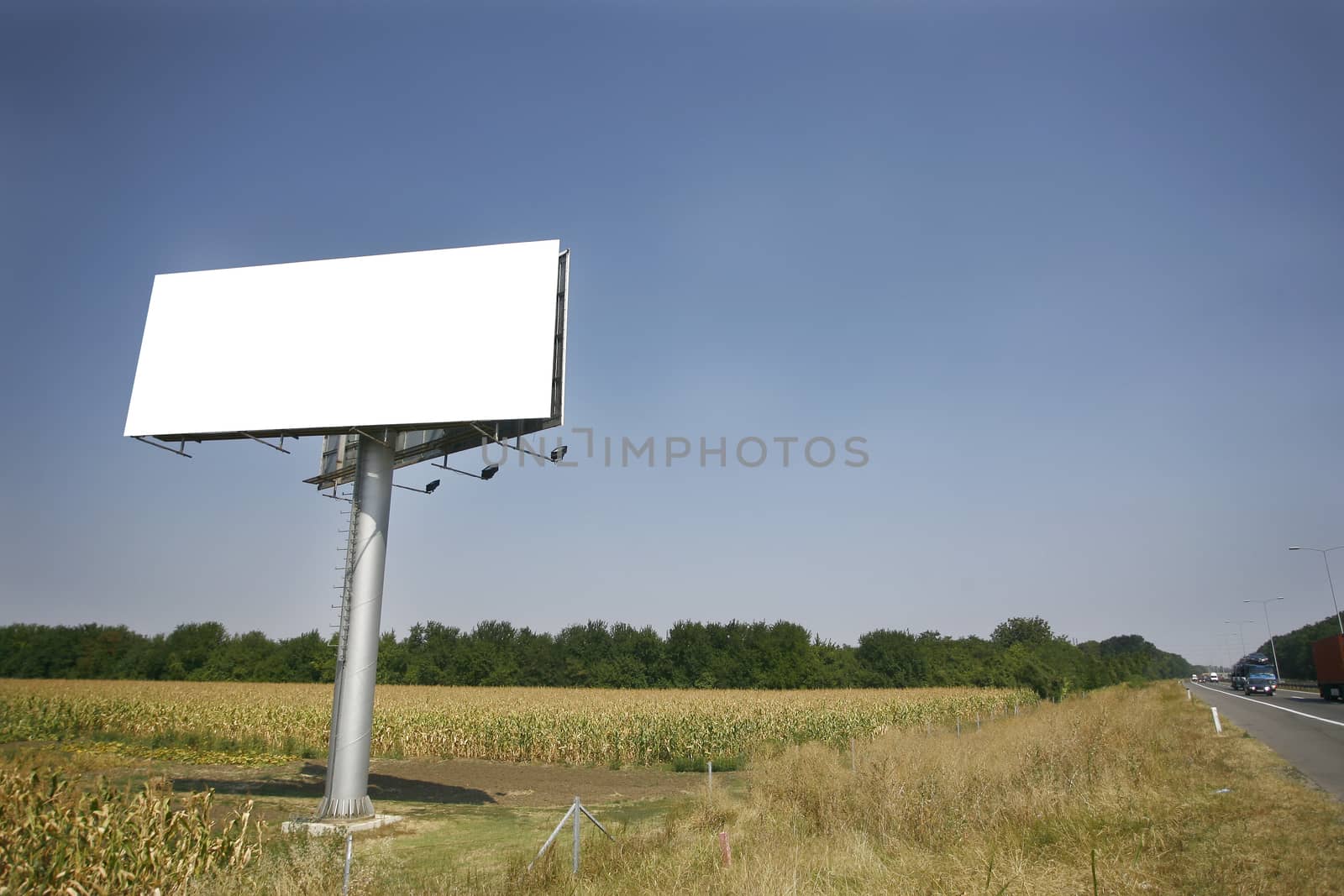 Empty billboard on background of sunset sky for your advertisement