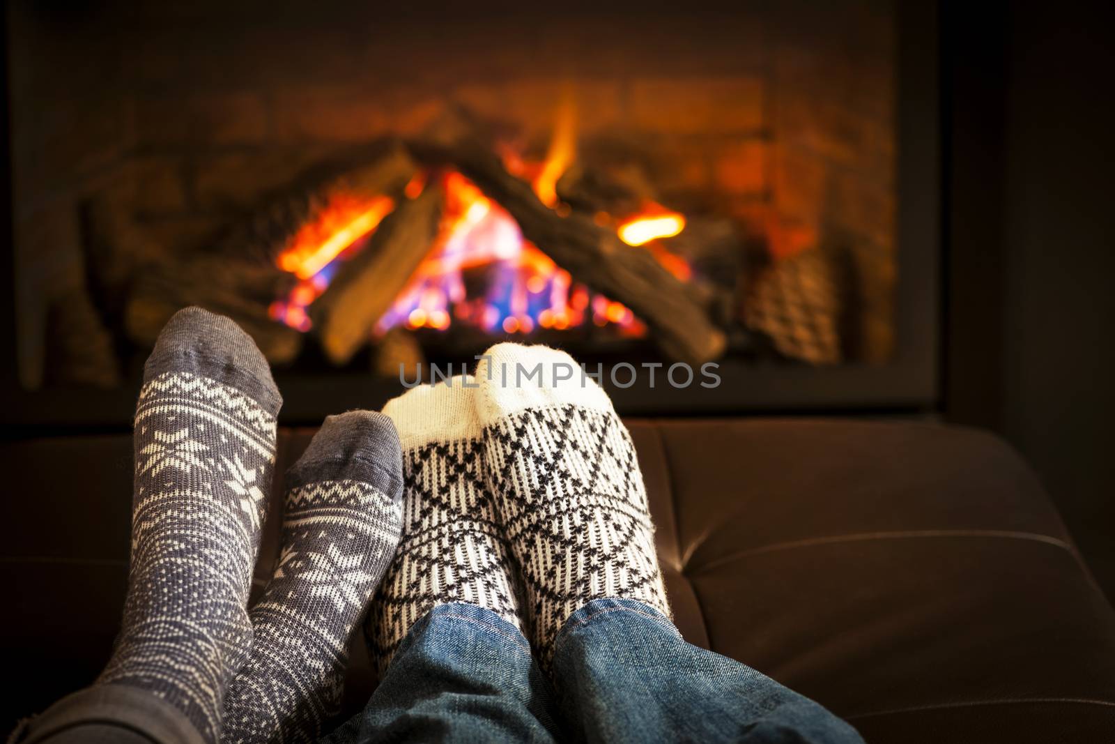 Feet in wool socks warming by cozy fire