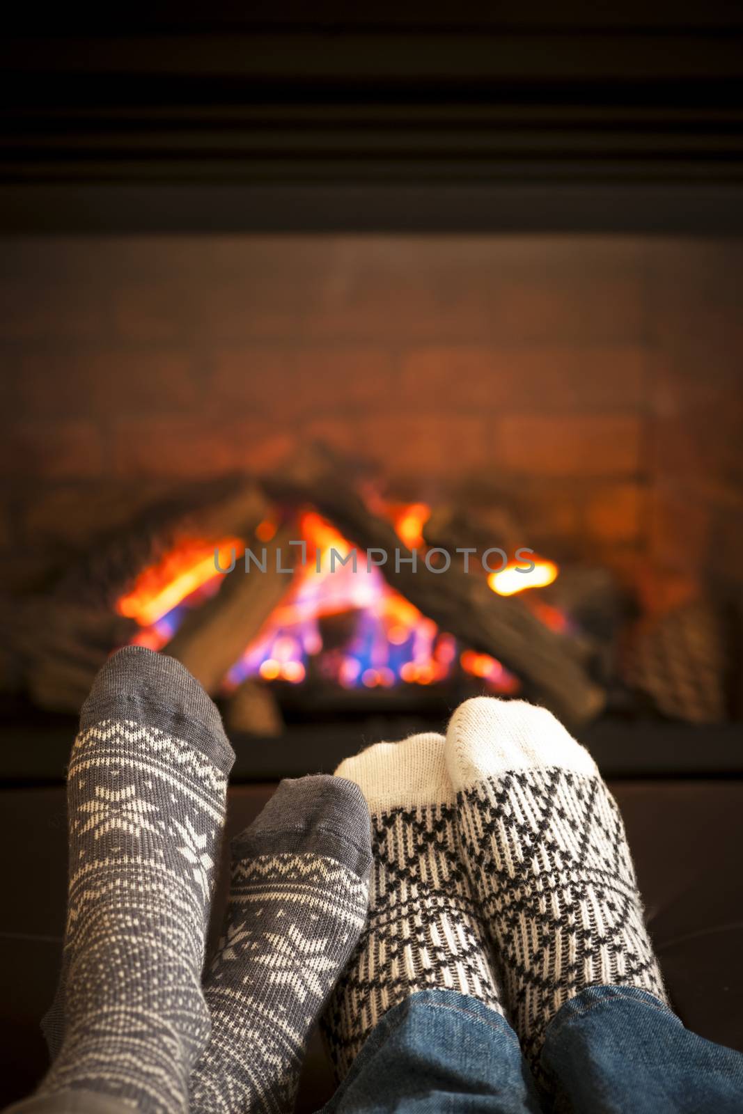 Feet warming by fireplace by elenathewise