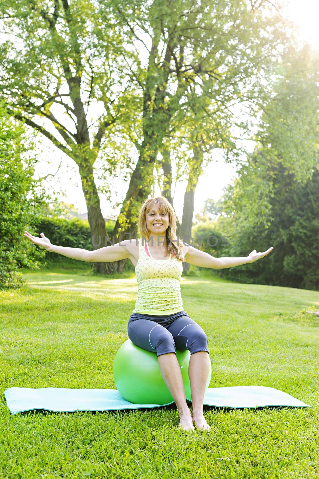 Woman on yoga balance ball by elenathewise