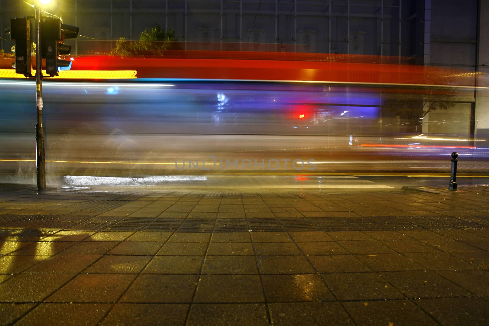 Long exposure in night traffic on road and pedestrian crossing
