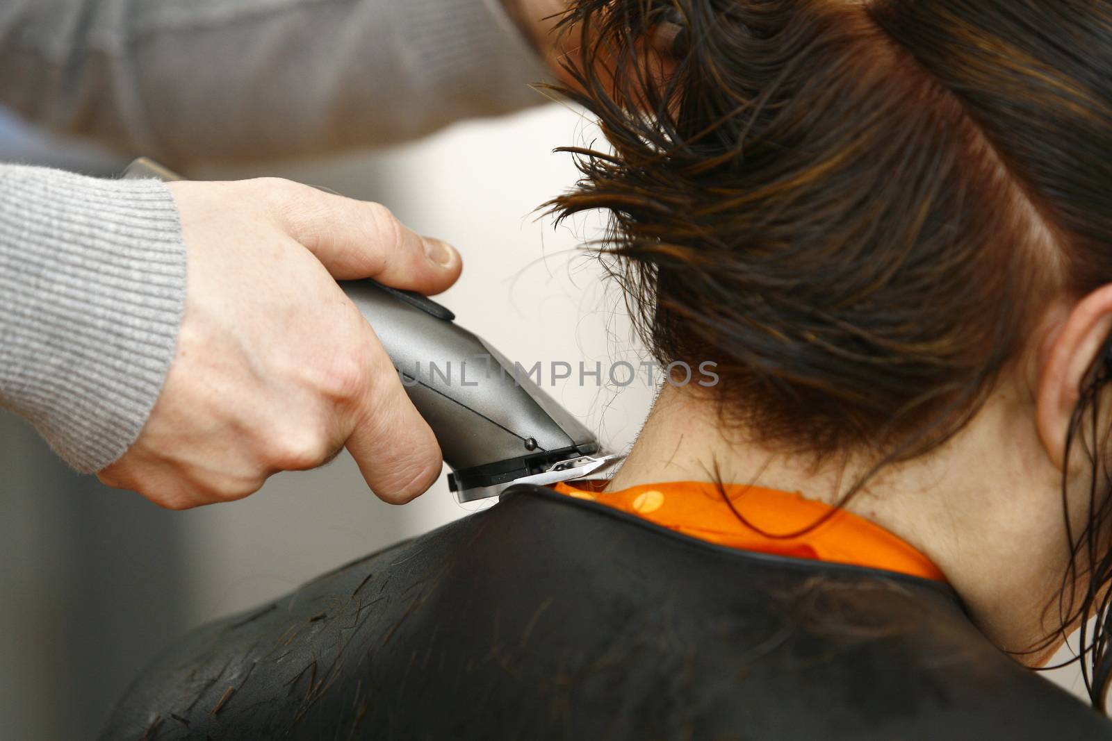 Hairdresser cutting hair in hairdresser salon