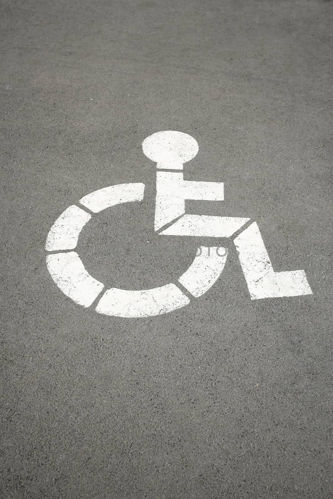 white sign for handicapped who indicates parking space