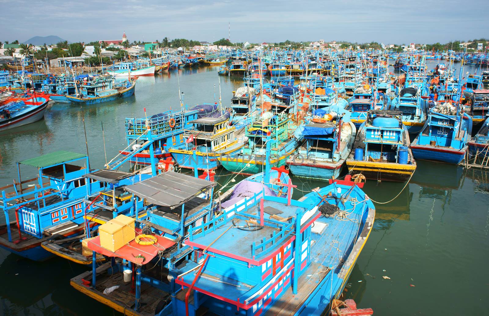 Many multicolor fishing boat anchor like a net at fishing port, with blue tone in horizontal frame. 