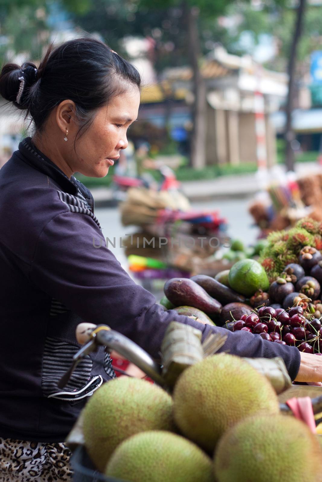 SAI GON, VIET NAM- JULY 21: Street vendor with fruit store on bicycle , Sai Gon, Viet Nam on July 21, 2013