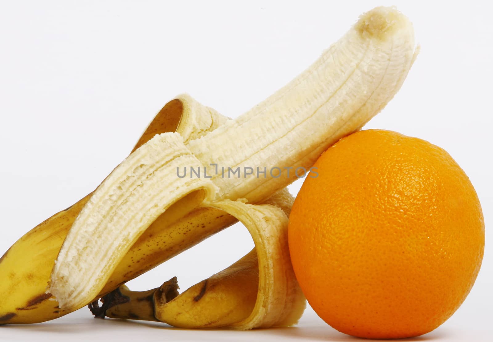 Fresh ripe bananas bunch and orange isolated on white background