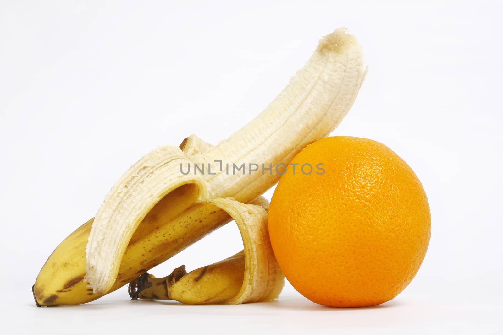 Fresh ripe bananas bunch and orange isolated on white background