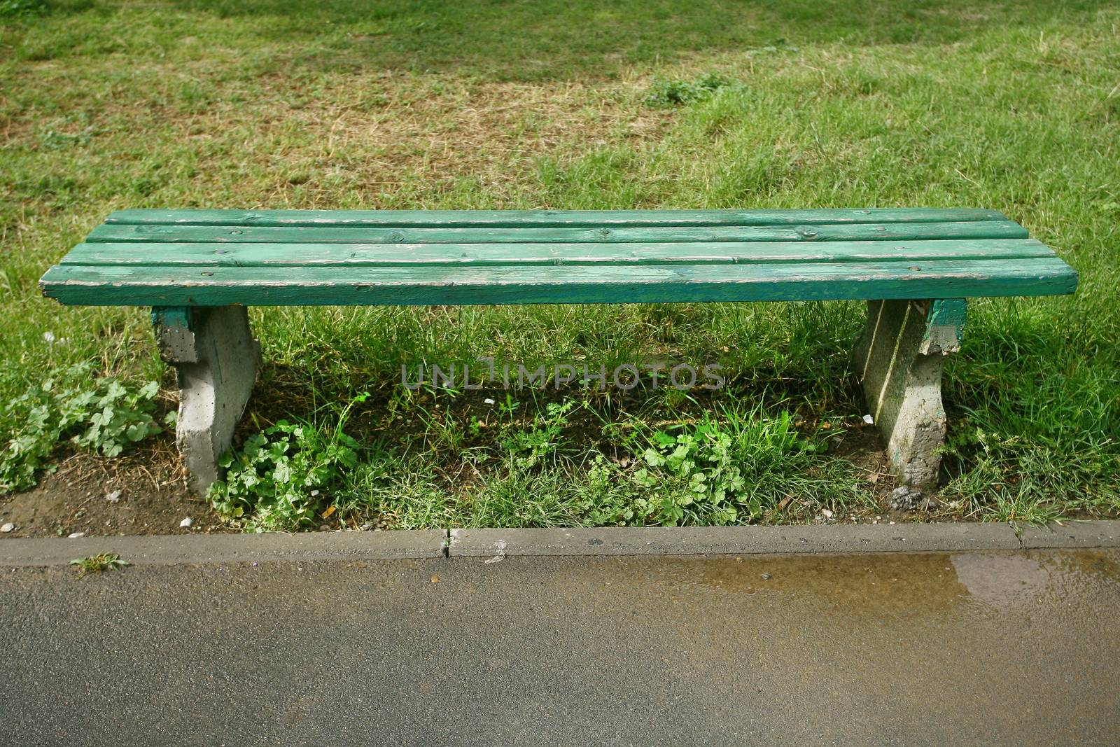 green wooden park bench at a park
