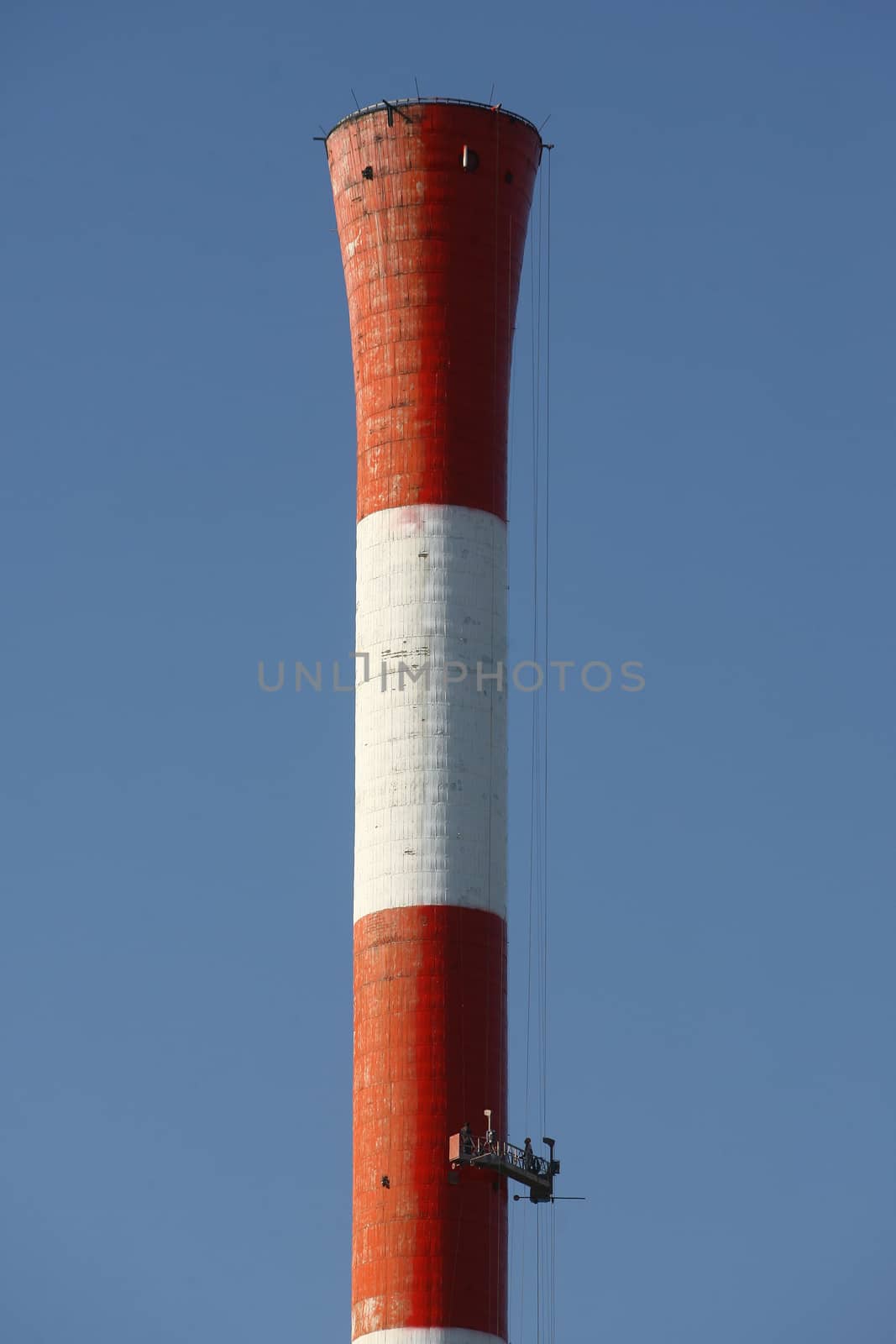 Heat and power central, smoke pipe against clear blue sky by nemar74