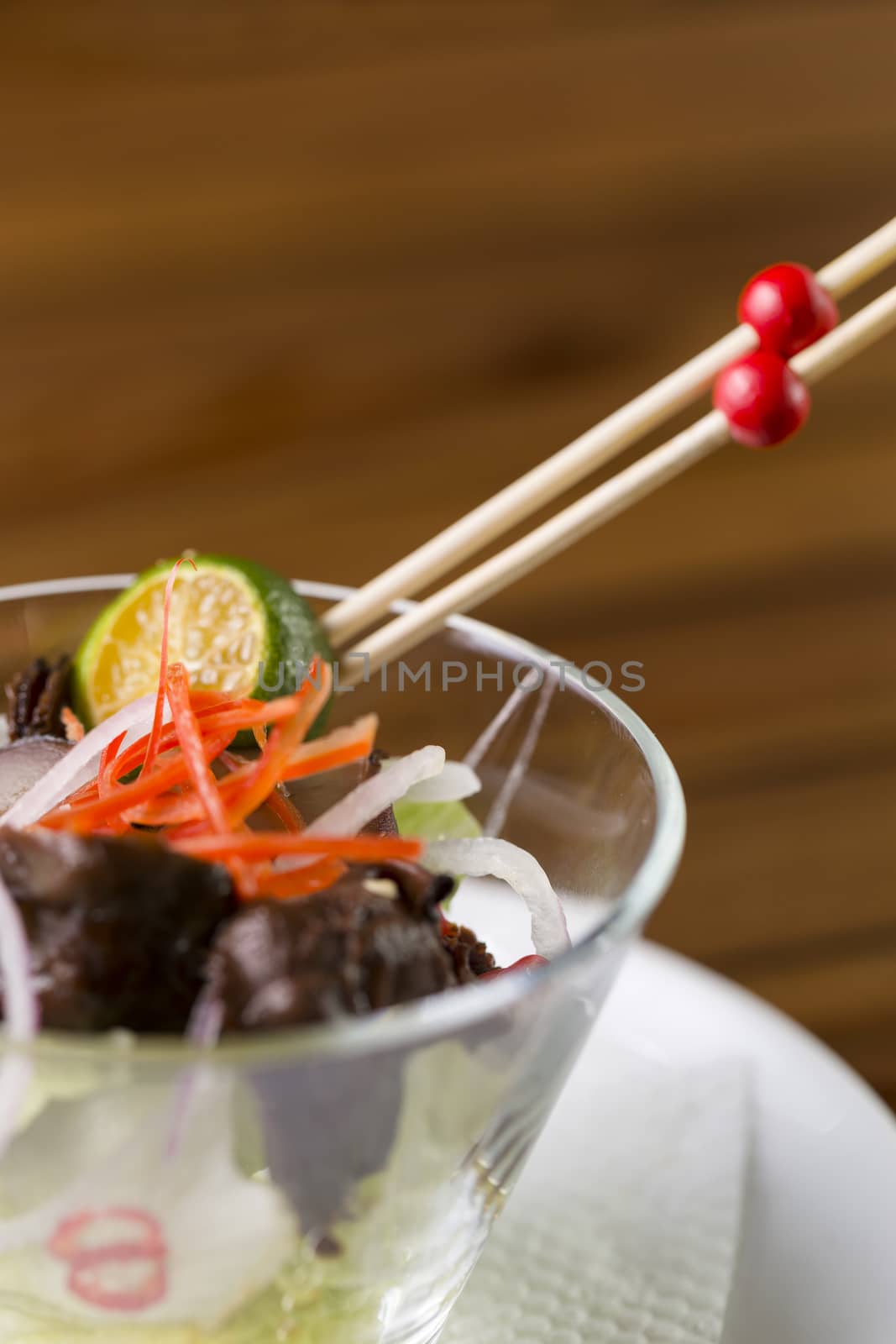 A close up of a glass of mushroom appetizer to be served.