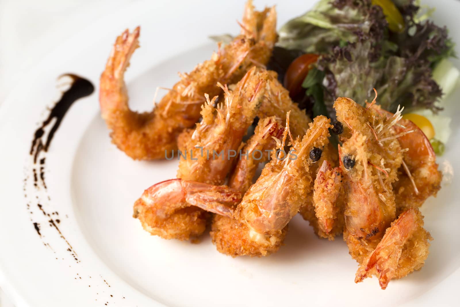 A close up plate of deep fried Prawns ready to be served.