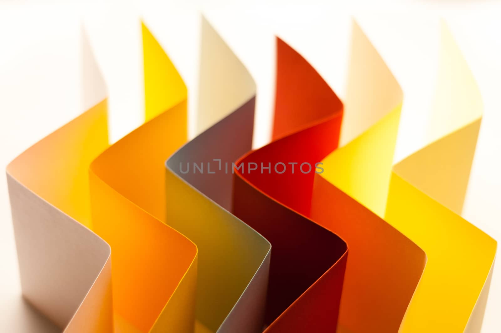 Colorful paper in unique shapes with shadow effect and selective focus.