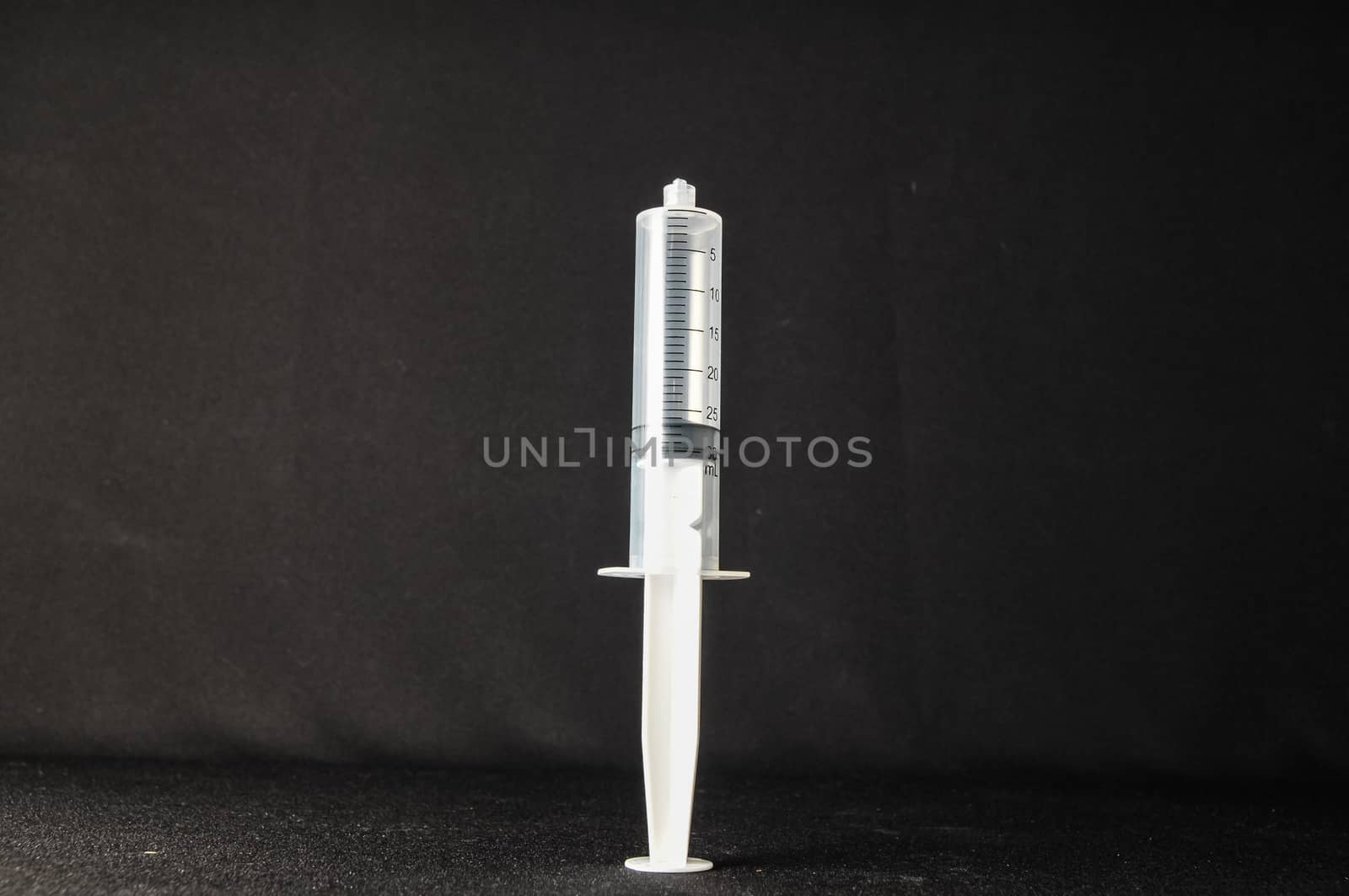 Black and White Syringe on a Dark Background