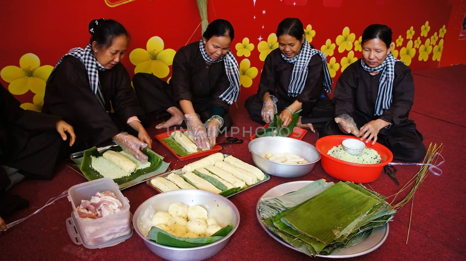 Group of people making traditional Vietnam food for Lunar New Ye by xuanhuongho