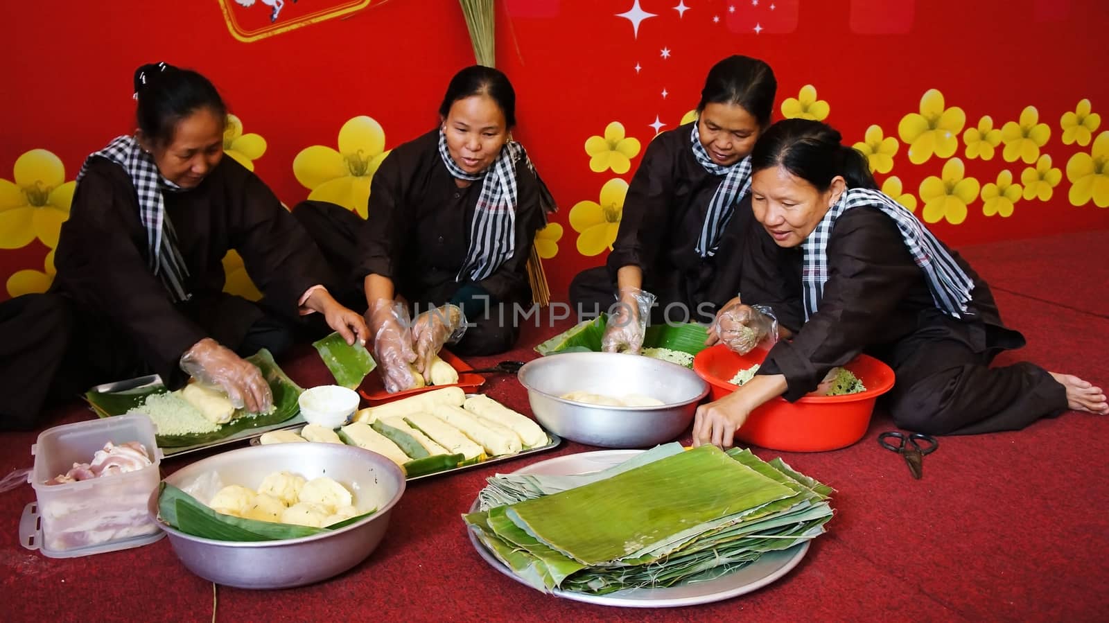 Group of people making traditional Vietnam food for Tet by xuanhuongho